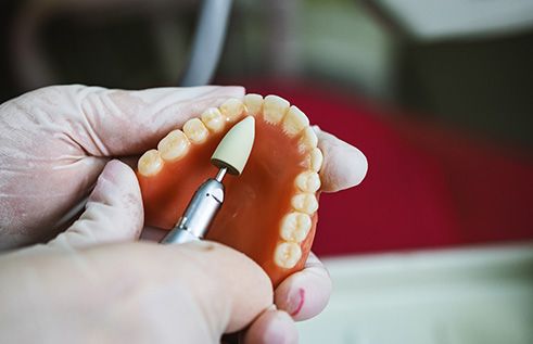 A dental lab technician making dentures
