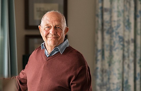 Senior man smiling at home