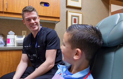 Dentist talking to a woman in the dental chair