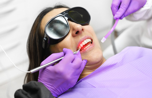 Woman receiving laser dentistry 