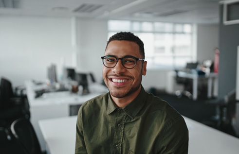 a smiling man with glasses