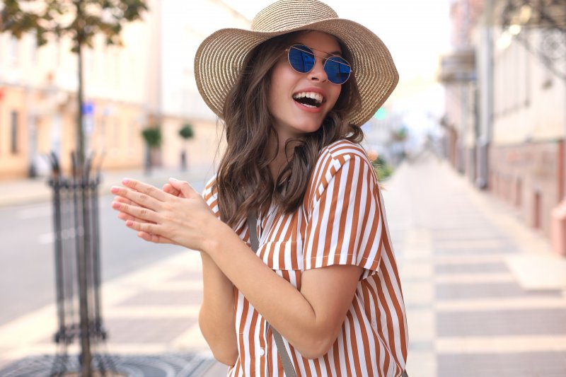 woman wearing summer hat and smiling