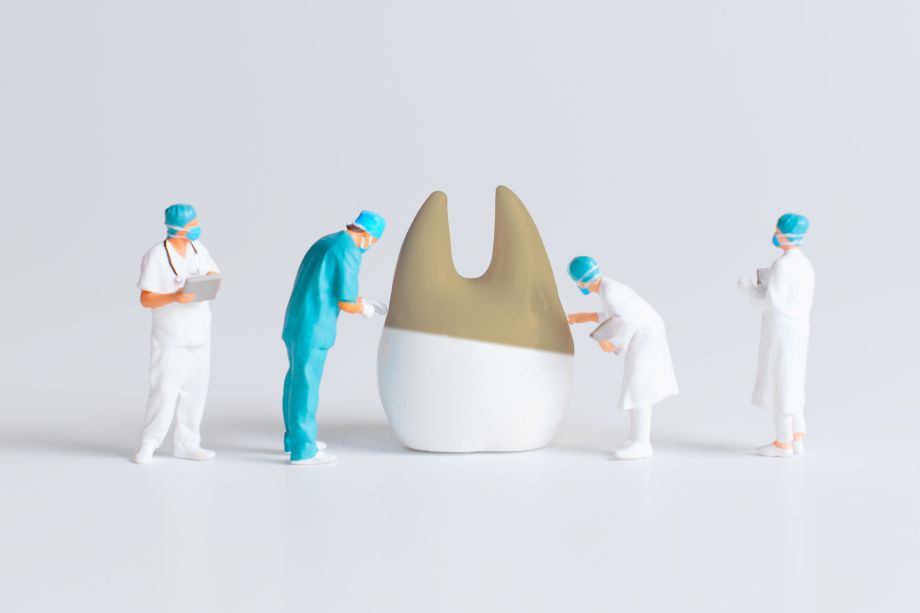 A computer-generated image of dentists cleaning a giant tooth