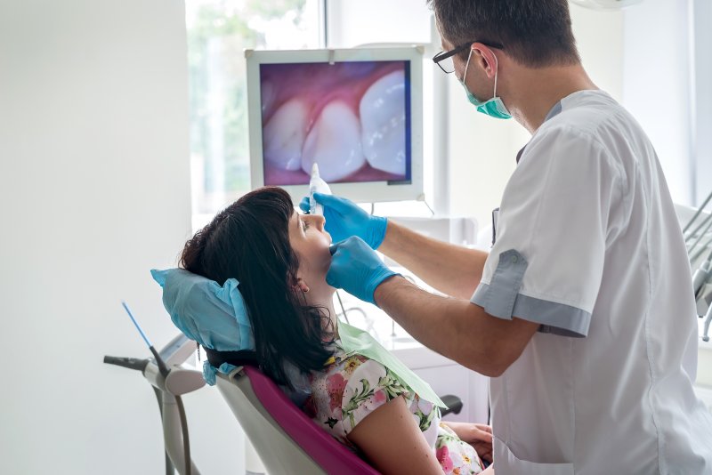 Patient talking to dentist using intraoral camera dental technology
